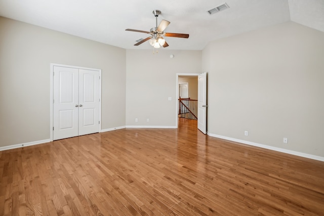 unfurnished room with ceiling fan, lofted ceiling, and light hardwood / wood-style floors