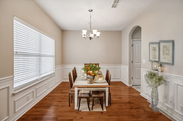 dining space featuring a chandelier, dark hardwood / wood-style flooring, and a wealth of natural light