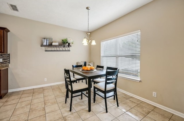 dining area featuring a notable chandelier and light tile patterned floors