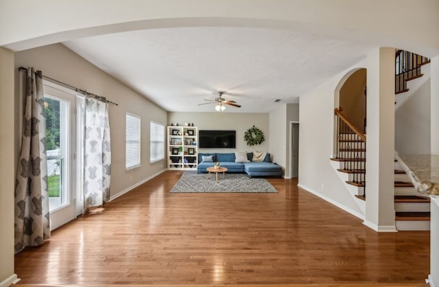 living room with hardwood / wood-style floors and ceiling fan