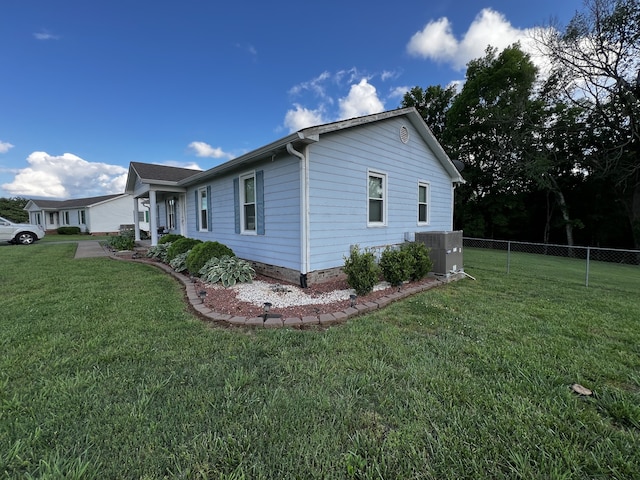 view of home's exterior featuring central AC unit and a lawn