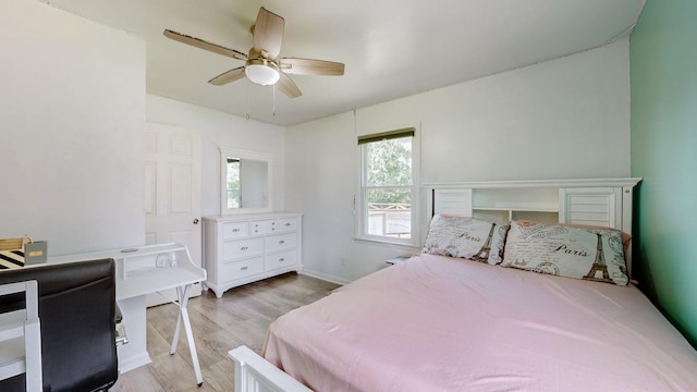 bedroom with light hardwood / wood-style floors and ceiling fan