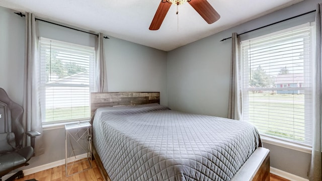 bedroom with ceiling fan and light wood-type flooring