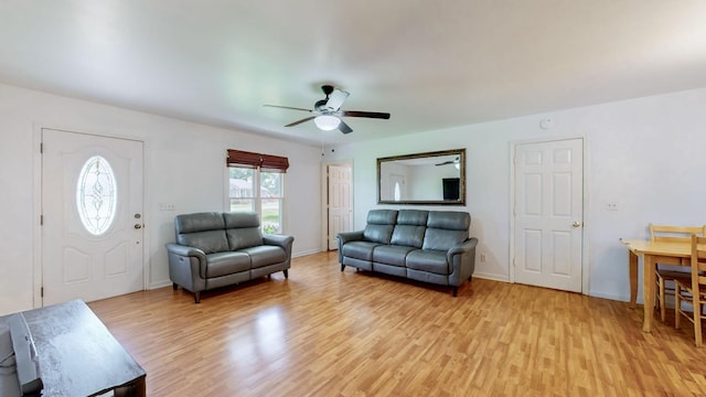 living room with light hardwood / wood-style flooring and ceiling fan