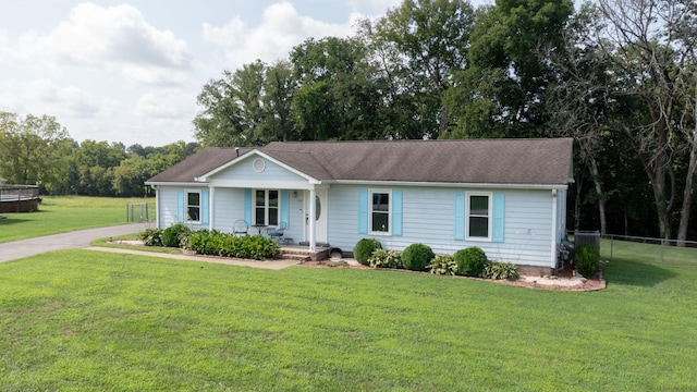 ranch-style house with covered porch and a front lawn