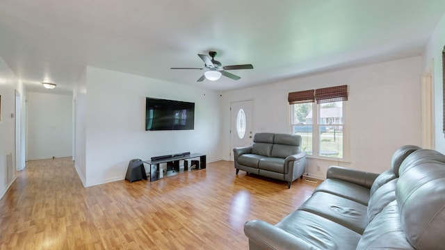 living room with ceiling fan and light hardwood / wood-style floors