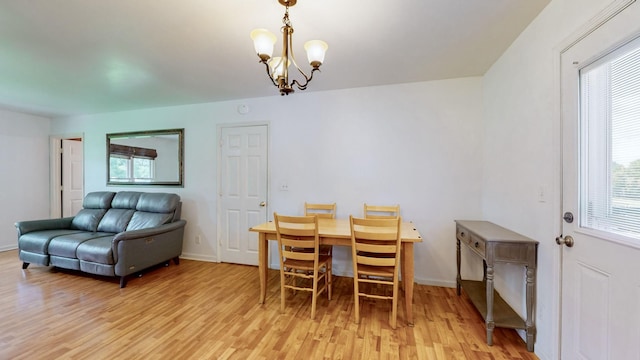 dining area featuring an inviting chandelier and light wood-type flooring