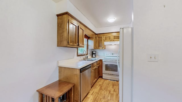 kitchen with sink, white appliances, and light hardwood / wood-style flooring