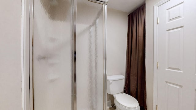 bathroom with walk in shower and toilet