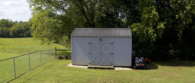 view of outbuilding with a yard