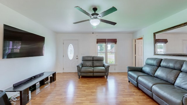 living room with ceiling fan and light hardwood / wood-style floors