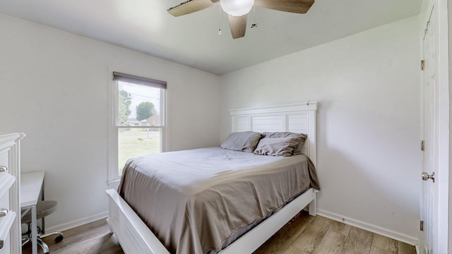 bedroom with wood-type flooring and ceiling fan