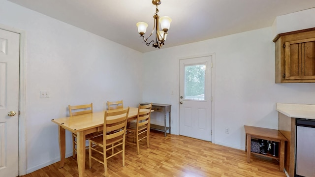 dining space with a chandelier and light hardwood / wood-style floors