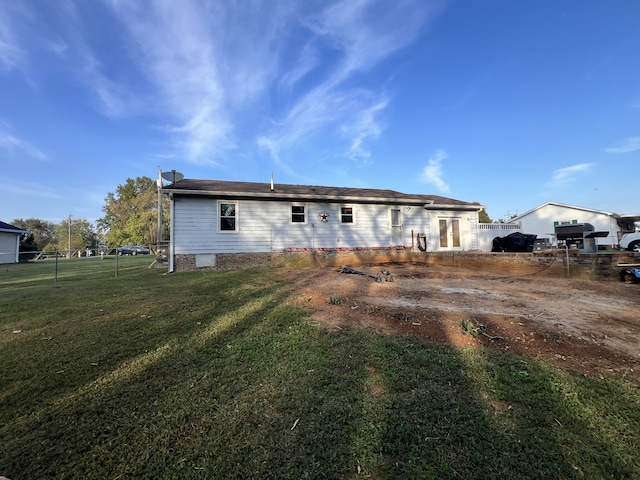 rear view of house featuring a lawn