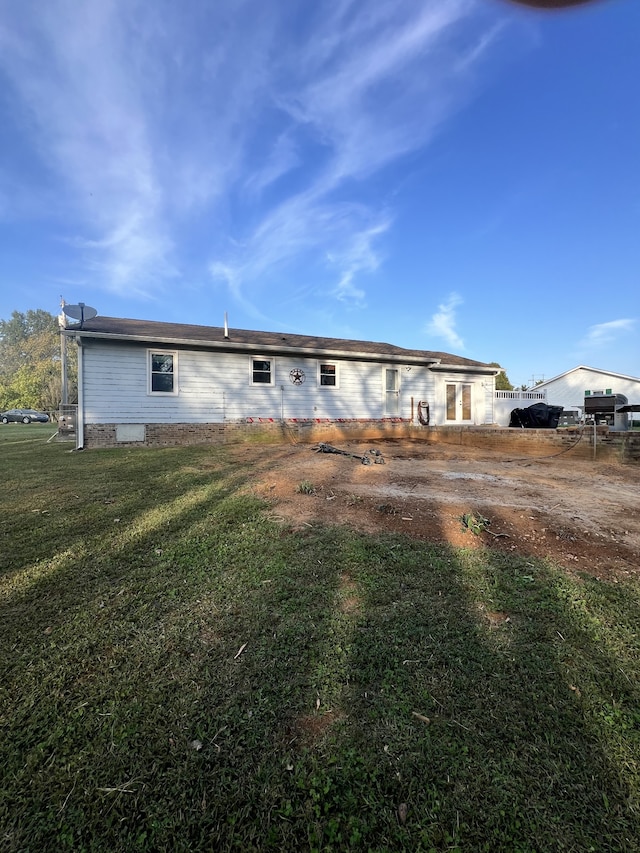 back of house with a lawn