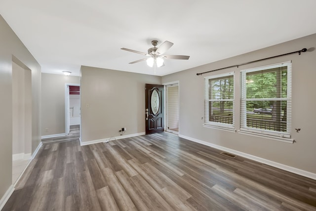 unfurnished room with hardwood / wood-style floors and ceiling fan