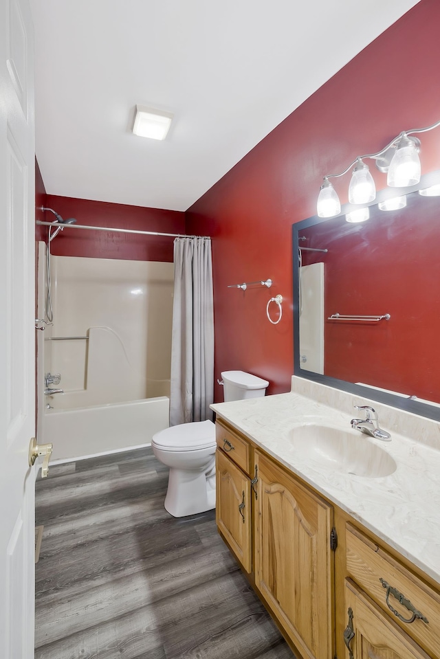 full bathroom with toilet, hardwood / wood-style floors, oversized vanity, and shower / bath combo with shower curtain