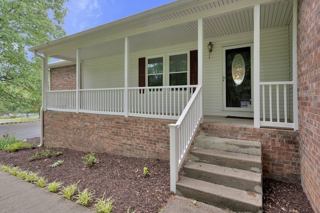 doorway to property featuring covered porch