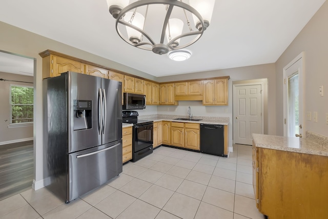 kitchen featuring light hardwood / wood-style floors, black appliances, light stone counters, a chandelier, and sink