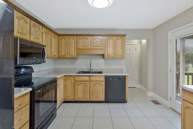 kitchen with sink, black appliances, and light tile floors