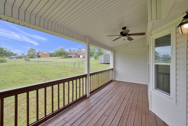 wooden terrace with a yard and ceiling fan