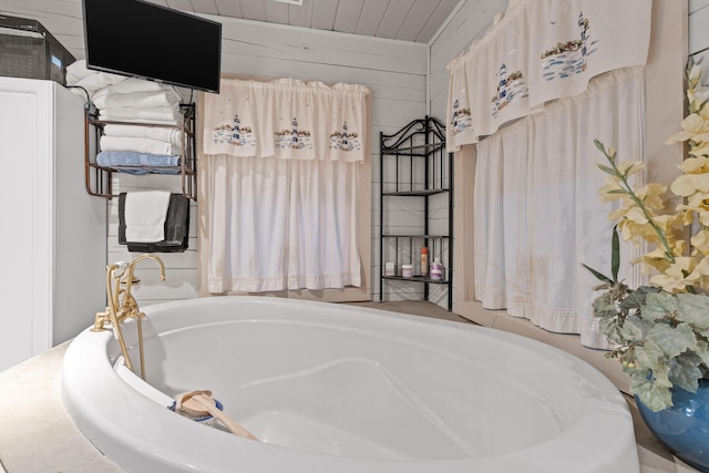 bathroom with a tub to relax in