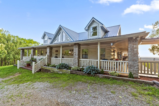 view of front of house featuring metal roof and a porch