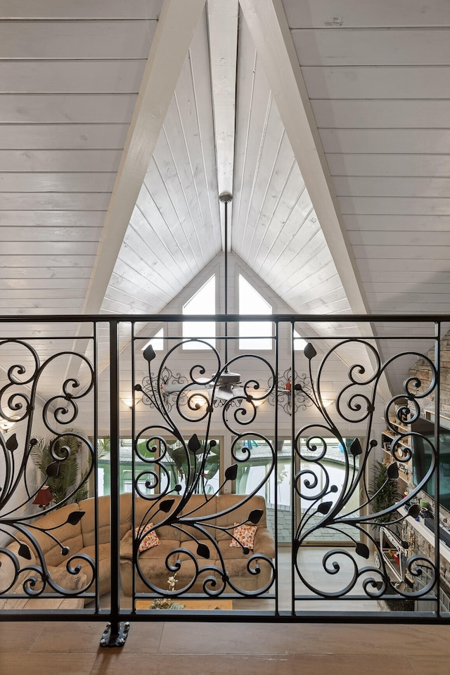 interior details with wood ceiling, a gate, beamed ceiling, and wood finished floors