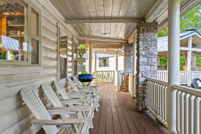 wooden deck featuring covered porch and grilling area