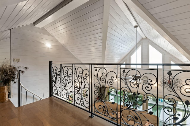 hallway with lofted ceiling with beams, wood walls, wood ceiling, and wood finished floors