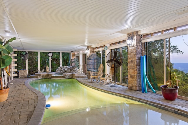 view of pool featuring a pool with connected hot tub and a patio area