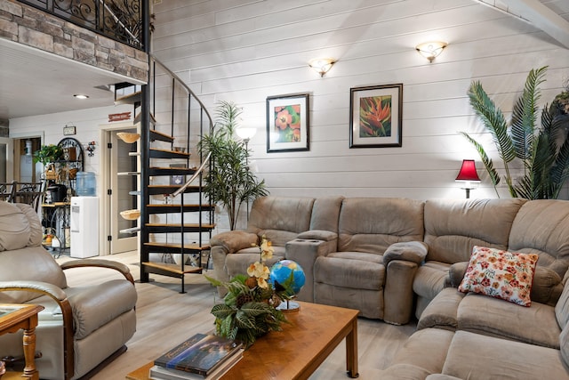 living room with stairs and light wood-style flooring