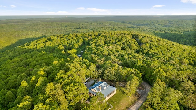 drone / aerial view with a wooded view