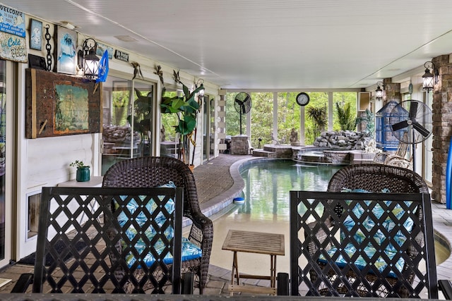 sunroom featuring a jacuzzi