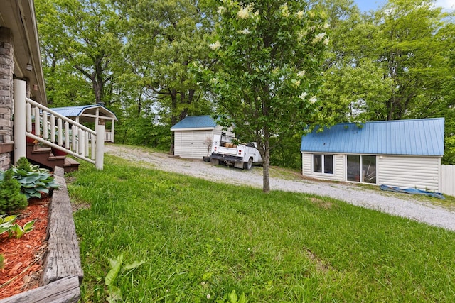 view of yard with an outbuilding and a shed