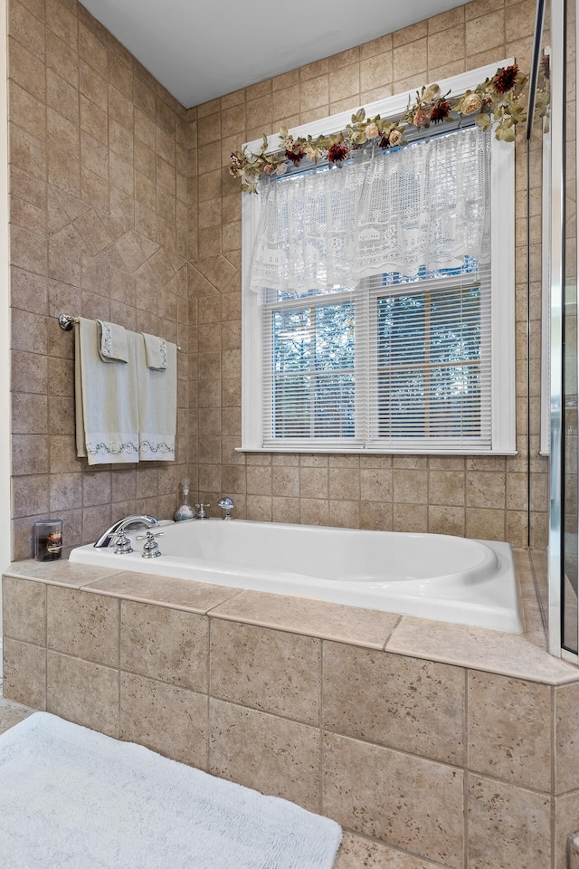 bathroom with tiled tub