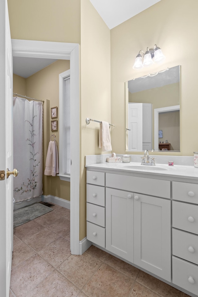 bathroom with vanity, tile patterned floors, and walk in shower