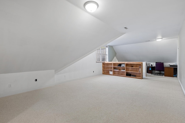 additional living space with lofted ceiling and carpet