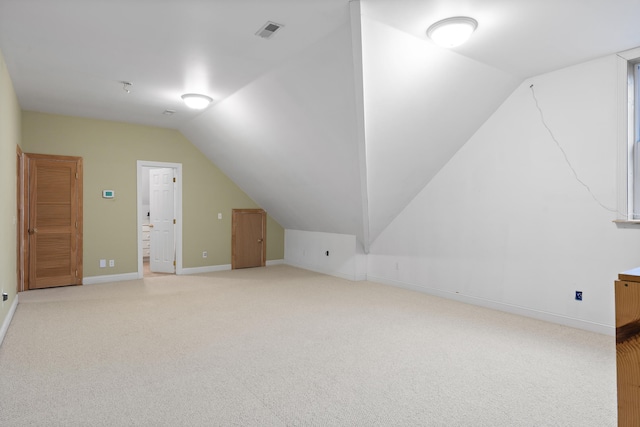 bonus room featuring lofted ceiling and light colored carpet