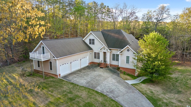 view of front of home featuring a front lawn, a garage, and a balcony