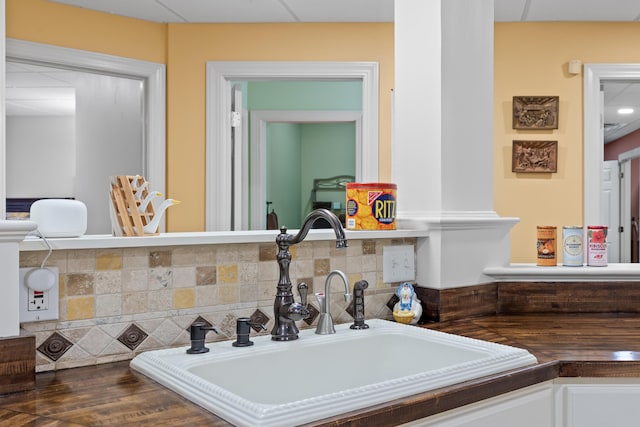 room details featuring sink and decorative backsplash