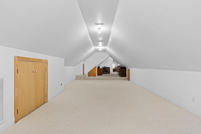 bonus room with lofted ceiling and carpet floors