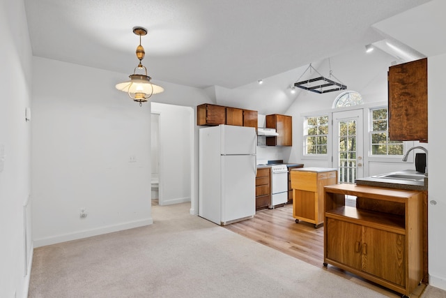 kitchen with lofted ceiling, extractor fan, light carpet, sink, and white appliances