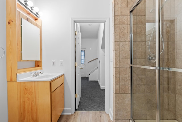 bathroom featuring vanity, hardwood / wood-style flooring, and an enclosed shower