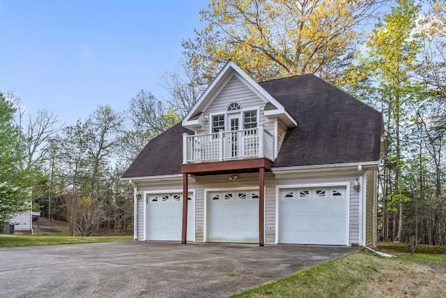 view of front of house featuring a balcony and a garage