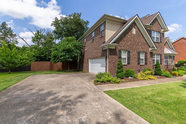 view of front of property featuring a garage and a front lawn