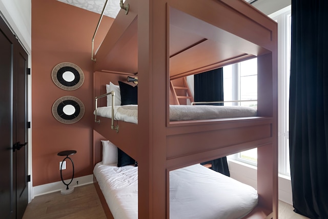 bedroom featuring light hardwood / wood-style flooring and multiple windows