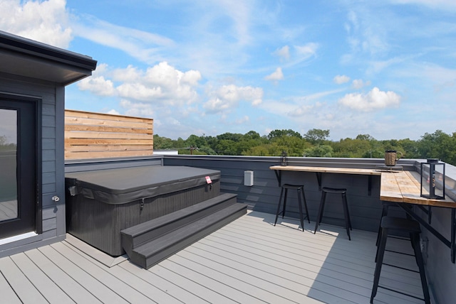 wooden deck featuring a hot tub