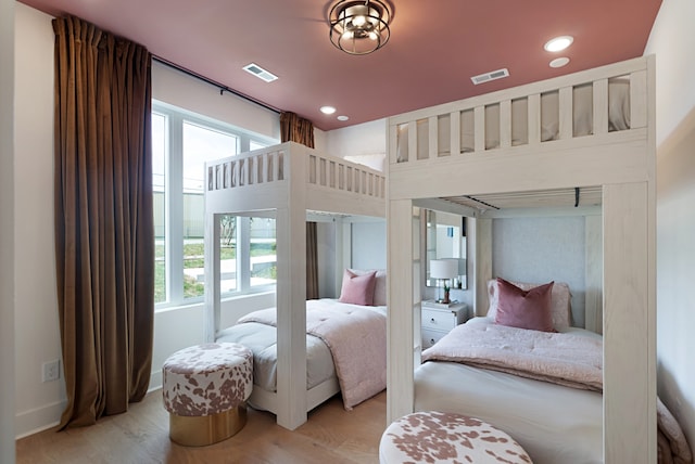 bedroom featuring light wood-type flooring and multiple windows