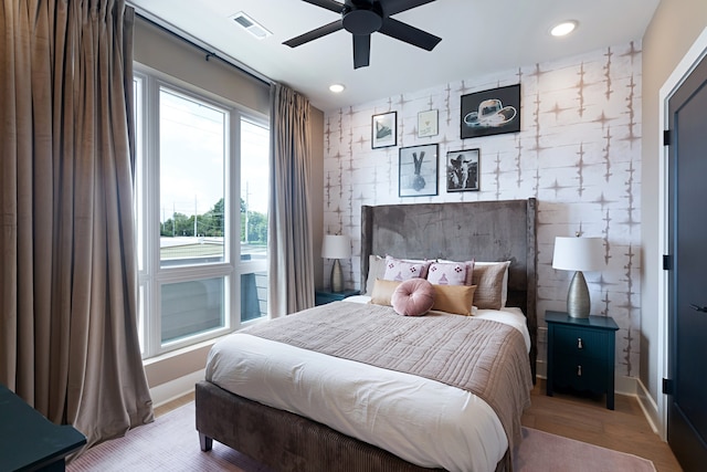 bedroom with ceiling fan and light wood-type flooring